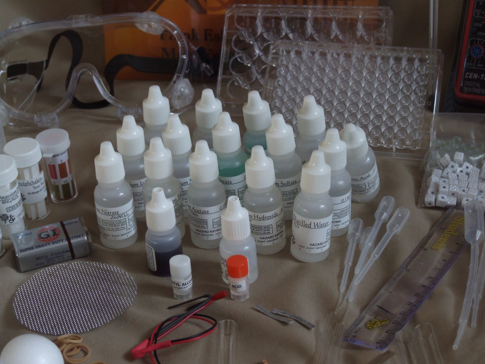 Premixed reagent bottles with hazard ratings, well plates and goggles