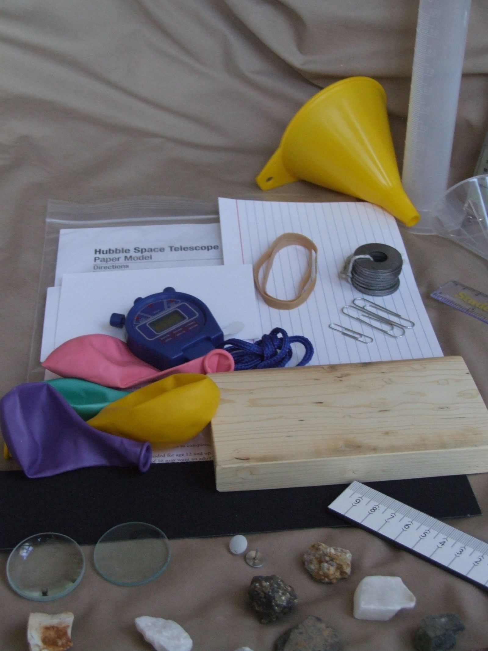 Stopwatch, balloons, weights and a wood block from the physical labs