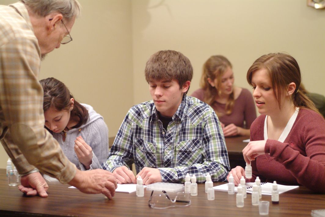 Students running a micro-scale chemistry lab at a table